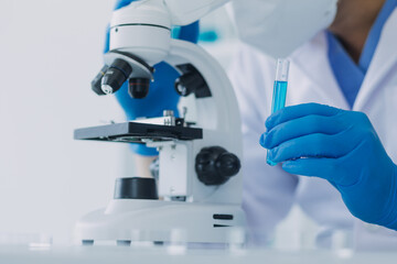 Medical Development Laboratory: Caucasian Female Scientist Looking Under Microscope, Analyzes Petri Dish Sample. Specialists Working on Medicine, Biotechnology Research in Advanced Pharma Lab