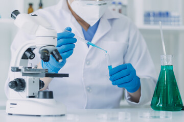 Fototapeta premium Medical Development Laboratory: Caucasian Female Scientist Looking Under Microscope, Analyzes Petri Dish Sample. Specialists Working on Medicine, Biotechnology Research in Advanced Pharma Lab