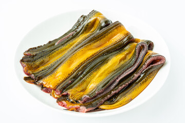 A plate of fresh boneless eel meat on a white background
