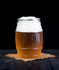 Glass of beer on wood table isolated on black background - 600826826