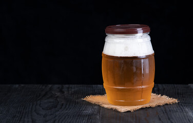 Glass of beer on wood table isolated on black background