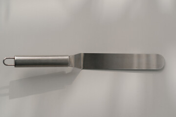 pastry spatula palette knife cooking utensils for cakes on the table on a white background close-up