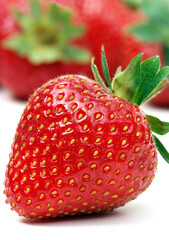 Stawberry on white with out of focus strawberries in background