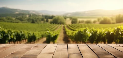 Tuinposter Wooden floor with blurred french vineyard background. Generative AI © Farnaces