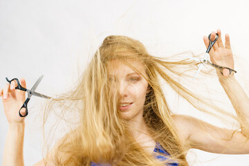 Young woman with scissors for haircutting