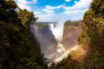 A double-rainbow provides a touch of magic at the spectacular Victoria Falls in Zimbabwe - obrazy, fototapety, plakaty