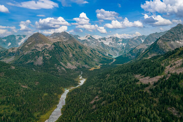 Blue river meander in green forest vegetation of delta Multinskoye lake in mountains Altai sunset, Aerial top view