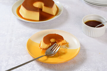 A pudding plate with a fork on top shows a sampled pudding