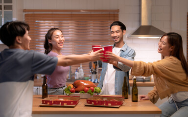 Group of Asian friends enjoying an evening party together at home.