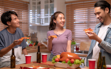 Group of Asian friends enjoying an evening party together at home.