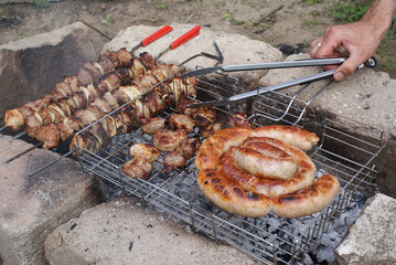 Sunday barbecue: different types of meat are roasted on the fire.