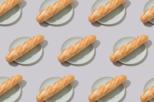 Creative food pattern with fresh french baguettes on plates. Minimal concept.