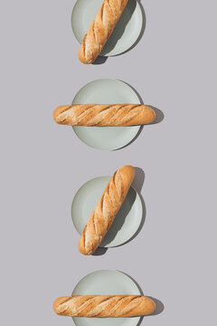 Creative food pattern with fresh french baguettes on plates. Minimal concept.