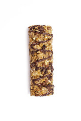 Muesli bar on a vertical white isolated background. Whole grain energy bar with chocolate. Healthy food in the form of a sweet healthy bar. Healthy quick snack