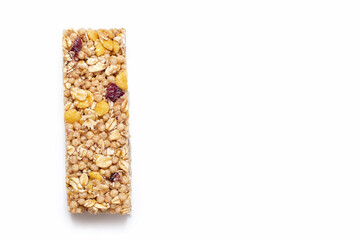 A muesli bar made from oatmeal on a white isolated background. Healthy sweet dessert snack. Cereal muesli with nuts, oatmeal and berries on a white background. Free space for text