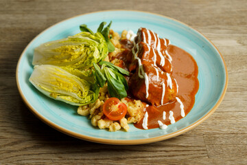 Chicken with paprika sauce, noodles with egg, sour cream and vegetables