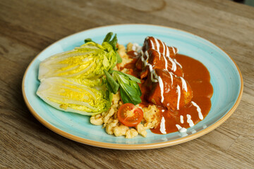 Chicken with paprika sauce, noodles with egg, sour cream and vegetables