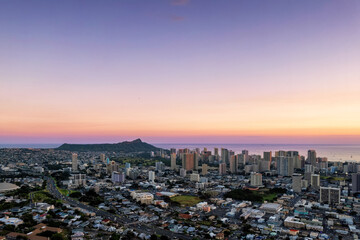 Aerial photo of Honolulu at sunset, including Diamond Head and Waikiki in the distance