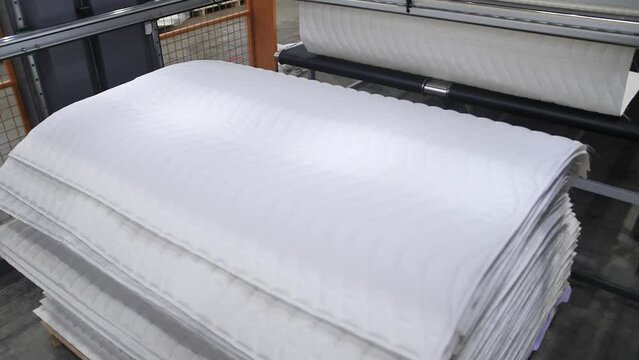 cutting foam rubber for the production. Machine of planimetric cutting of foam rubber, cutting foam rubber, close up of cutting foam, factory for the production of mattresses