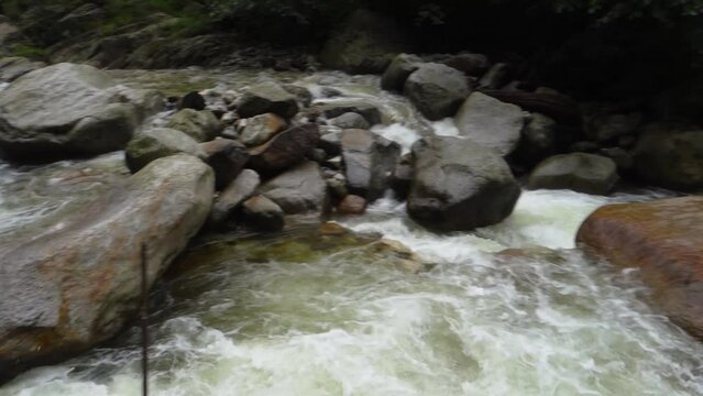 River flowing ( Barati Nala ) alongside Shrikhand Mahadev kailash Yatra trail through dense forest and Mountains. Himachal Pradesh India.