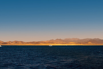Naklejka premium Beautiful view of the golden mountain coast from the azure sea. Red Sea, Egypt