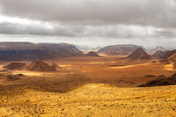 Fototapeta premium Top view of a canyon meandering through high sandstone mountains in the desert, Jordan