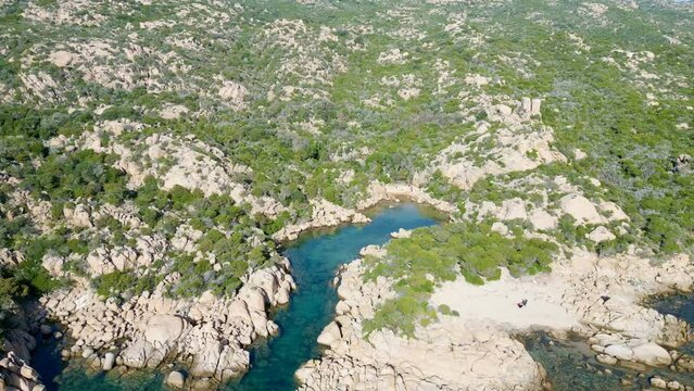 Tranquil Odyssey: An Aerial Perspective of a Creek near Capu Di Fenu, Bonifacio, Corsica - Balancing Turquoise Waters, Rocky Shoreline, Serene Beach, and Verdant Foliage
