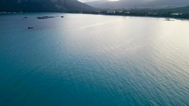 Serenity Unveiled: A Panoramic Aerial Journey Over Santa Giulia Beach, Porto-Vecchio, Corsica - A Blend of Azure Waters, Majestic Mountains, and Ethereal Mists