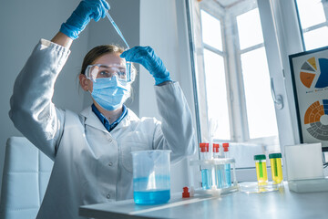 Scientist, chemist conducting an experiment on the synthesis of a new pharmaceutical drug in the...