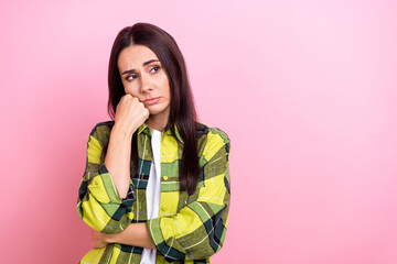 Photo of bored unhappy woman dressed plaid shirt arm cheek looking empty space isolated pink color background
