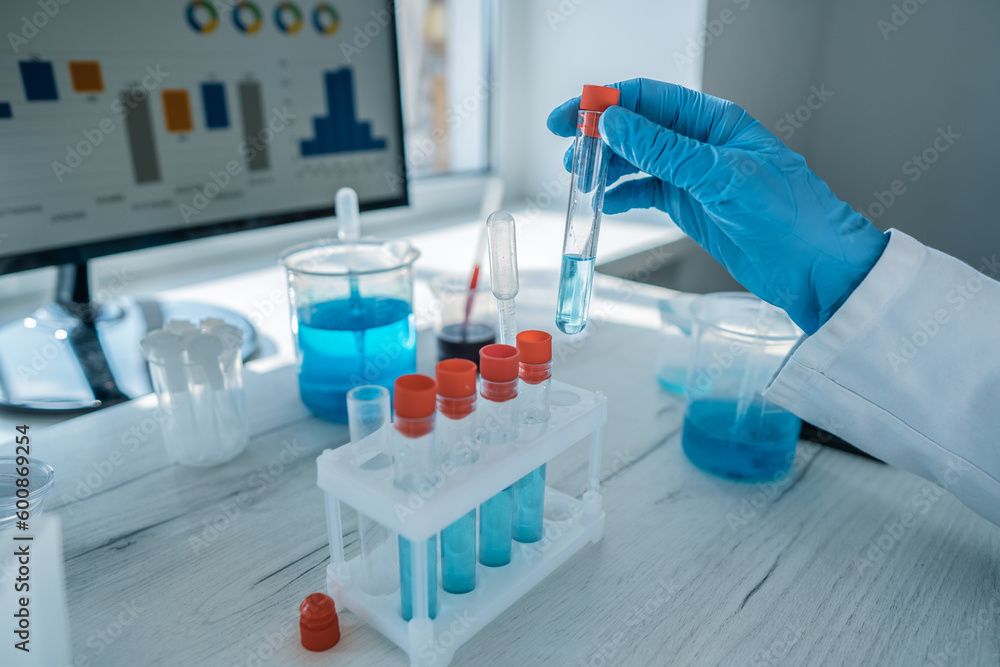 Poster photo shows a chemist analyzing chemical compounds in a laboratory to identify potential health and 