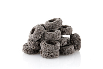 Heap of black cereal rings isolated on white background, delicious and useful rings breakfast cereal, view close-up