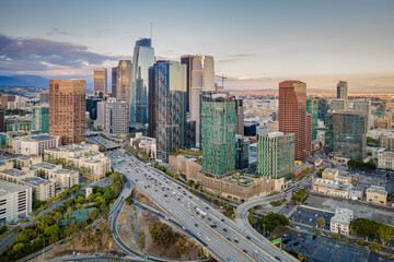 Fototapeta na wymiar Los Angeles, California – May 3, 2023: aerial drone view toward LA downtown buildings with freeway 110 including hotel Indigo, Metropolis Los Angeles