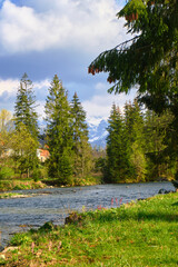 Beautiful spring panorama over river to snowy Witow, Tatra mountains, Poland