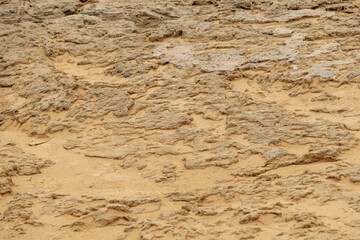 Brown abstract background of clayey sand texture. Soft focus