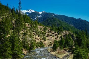 Beautiful spring panorama over river to snowy Witow, Tatra mountains, Poland