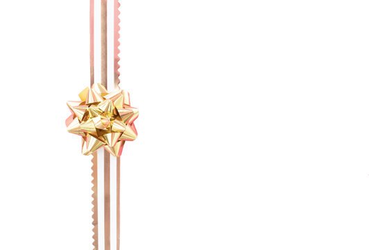 Rose gold decorative bow on a gold stripe PNG. Birthday and party gift decoration concept.