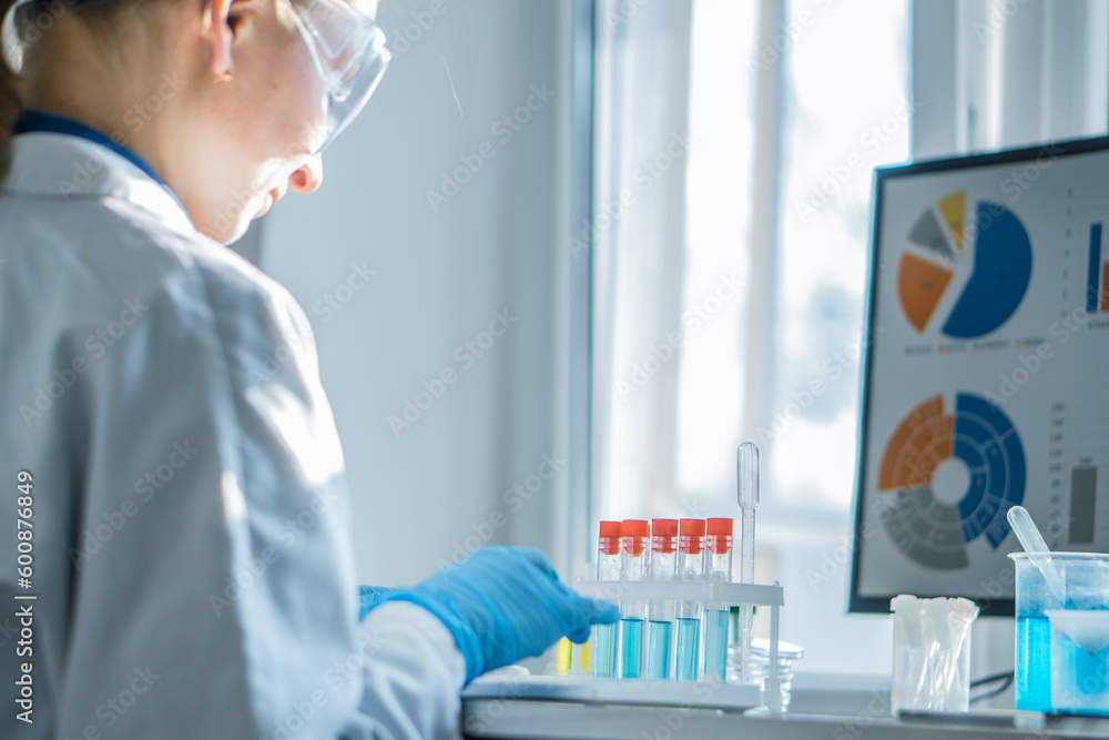 Poster A medical laboratory assistant concentrates on analyzing the results of his work on computer in biotechnological laboratory. Chemist analyzes data in a pharmaceutical laboratory to develop new drugs