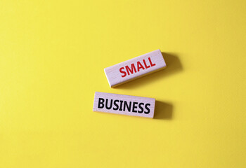 Small business symbol. Concept words Small business on wooden blocks. Beautiful yellow background. Business and Small business concept. Copy space.
