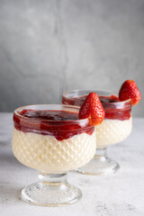 Dessert of creamy pudding and strawberry jam. Panna cotta.