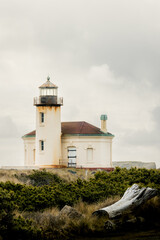 Fototapeta na wymiar Coquille River Lighthouse in Bandon Oregon USA in Bullards Beach State Park on Southern Oregon Coast on bright overcast day. Vertical no people.