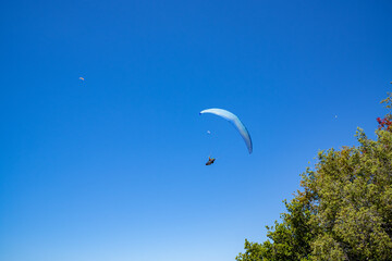 Paragliding in the sky. Aerial view of paraglider and Blue Lagoon in Oludeniz, Babadag, Mugla, Turkey.