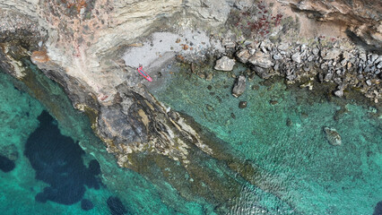 Aerial drone photo of rocky tropical exotic paradise island bay with deep turquoise sea forming a blue lagoon © aerial-drone