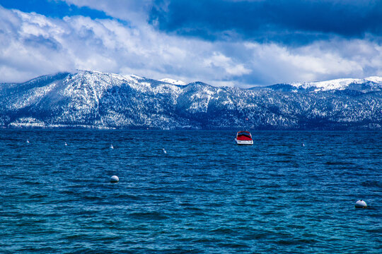 View Of Lake Tahoe From The North Side With A Single Boat Docked In The Water, Looking Over To The Northeast Side Of Incline Village