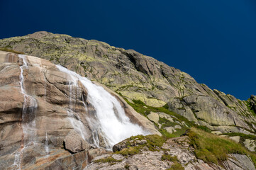 Fototapeta na wymiar small waterfall of a mountain creek at Grimselpass