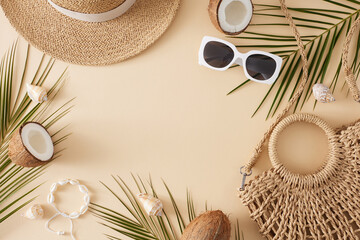 Vacation time concept. Top view flat lay of trendy bag, stylish sunhat, shell bracelet, sunglasses, coconut and palm leaves on pastel beige background with blank space for text or advert