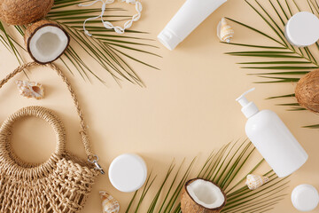 Fototapeta na wymiar Protect your skin, love the sun. Top view flat lay mockup cosmetic bottles, stylish bag, coconut, palm leaves and seashells on pastel beige background with space for text or advert