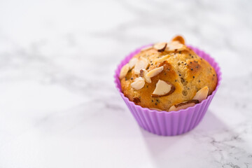 Lemon poppy seed muffins garnished with almond slivers