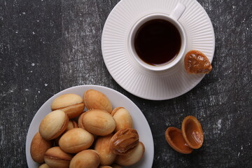 photo of homemade peanuts on a plate and a cup