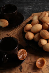 photo homemade peanuts on old newspapers and a cup of coffee